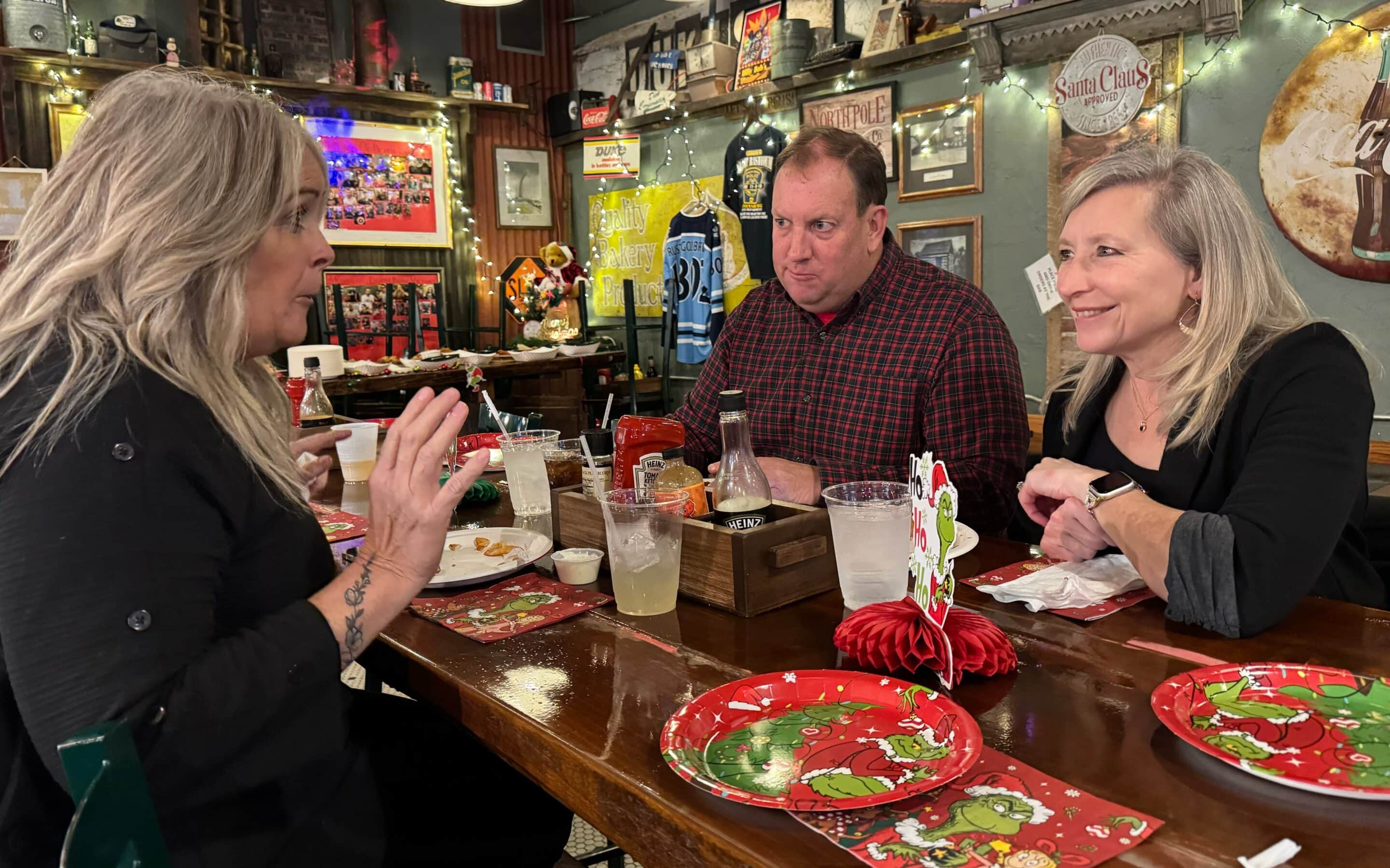 Three chamber members having a conversation at the Christmas Party